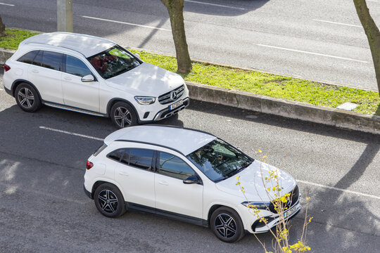 White mercedes benz suvs driving urban street