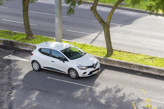 White renault clio car parked on urban street