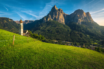Church of St Valentin on the green slope in Dolomites