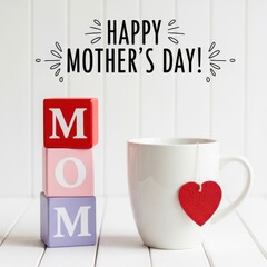 A heartfelt mother s day greeting with wooden blocks a mug and a red heart