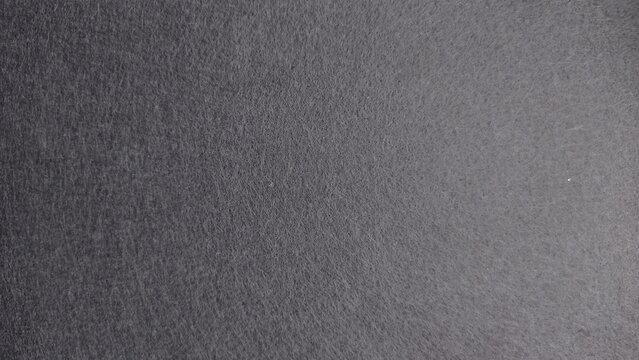 Gradient gray texture of horizontal felt fabric.