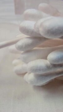 Macro shot of many white cotton ear buds in a container