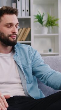 Bearded man wear headset talking by video call, involved at stream online communication, using videocall application. Male freelancer having virtual meeting on digital tablet at home. Slow motion.