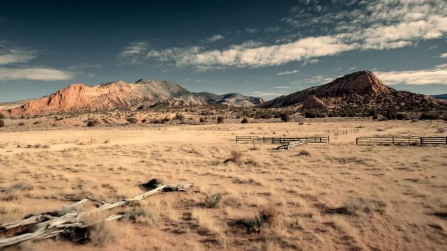 4K Rustic wooden fence gate in arid landscape with red rock mountains and blue sky video