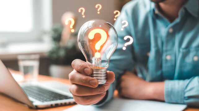 A glowing light bulb with question marks represents innovative problem solving