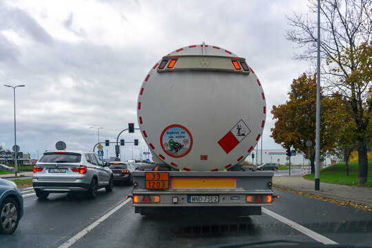 Fuel tanker truck stopped at intersection on red traffic light in urban road traffic