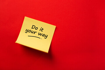 Yellow sticky note reading do it your way on red background