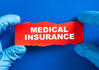 Hands in medical gloves holding a medical insurance concept