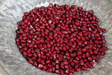 Pomegranate Seeds on Rustic Old Plate