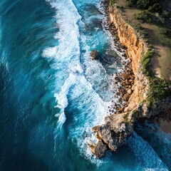 Aerial View: Turquoise Waves Crash Against Rugged Coastal Cliffs
