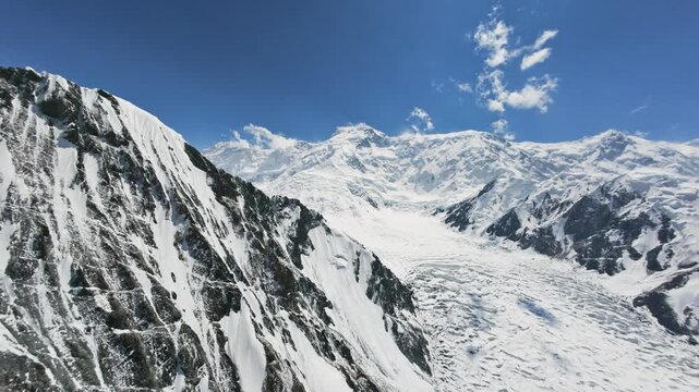 A beautiful bird's eye view of the Pobeda Peak ridge. Unique footage of Kyrgyzstan mountains. 4K