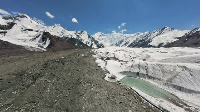 Drone flight over the glacier towards Pobeda Peak or Jengish Chokusu. Beautiful landscapes of Kyrgyzstan. 4K