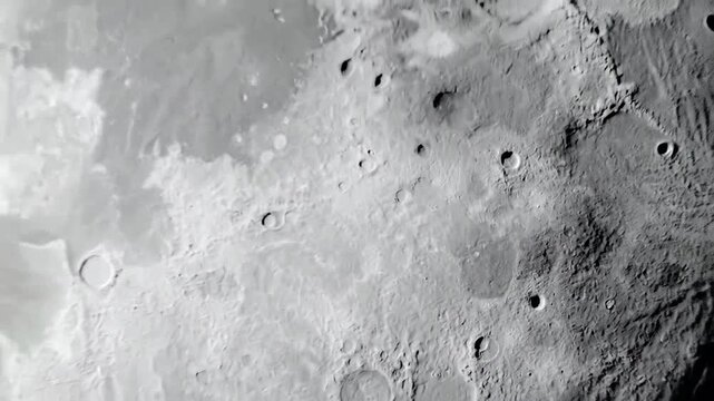 Monochromatic lunar surface texture with craters and rugged terrain, offering a stark, alien landscape.