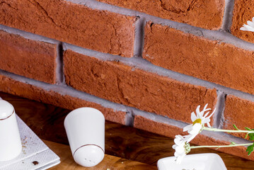 Rustic Kitchen Decor with Exposed Brick Wall and White Ceramic Accessories