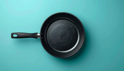 Top-Down View of a Non-Stick Frying Pan on Blue Background.