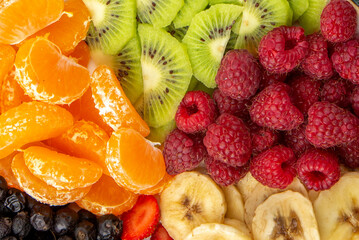 Fresh Tropical Fruit Salad Platter with Raspberries Kiwi Banana Slices and Tangerines
