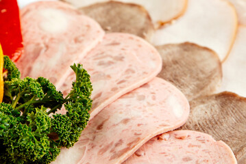 Sliced Cold Cuts Platter with Assorted Deli Meats and Fresh Green Parsley Garnish