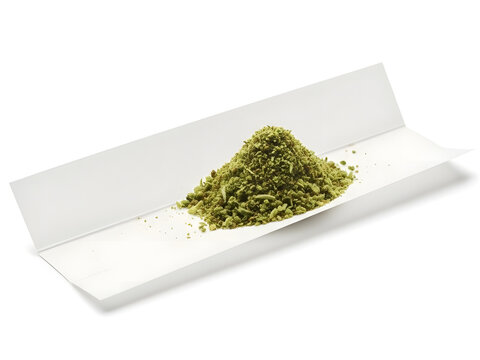 Rolling papers with ground herb ready for use, isolated on a white background
