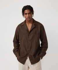 smiling filipino guy on oversized shirt fit model pose on white background