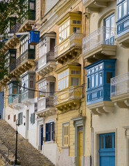 Valletta old town narrow street with traditional Maltese balconies and limestone facades