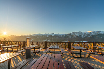 Tatry mountains with rising sun seen from Gubalowka hill near Zakopane. Poland