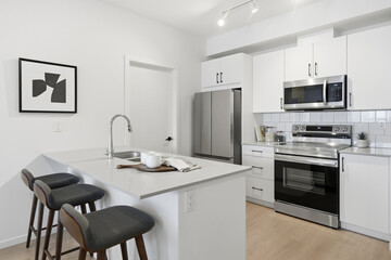 Kitchen with a white counter and a black chair