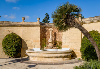 Garden building Valletta fortress with stone facade and fountain