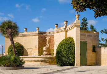 Garden building Valletta fortress with stone facade and fountain