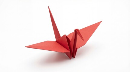 A beautifully crafted red origami crane symbolizing peace and hope on a clean white background