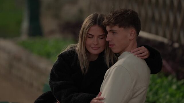 A young couple embraces in a romantic setting in Paris France The woman and man are in love and hugging outdoors The clip captures a portrait of the happy couple enjoying their time together in slow m