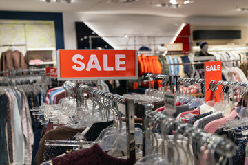Fashion retail sale sign inside clothing store