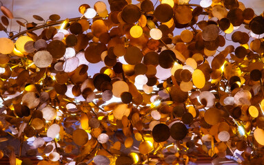 modern gold disc chandelier, numerous gold metal discs suspended in the air