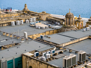 Valletta rooftops with air conditioning units and historic dome