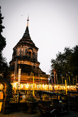 Obraz premium Wat Lok Moli temple in Chiang Mai. Traditional Buddhist temple with layered dark wooden roofs and ornaments.