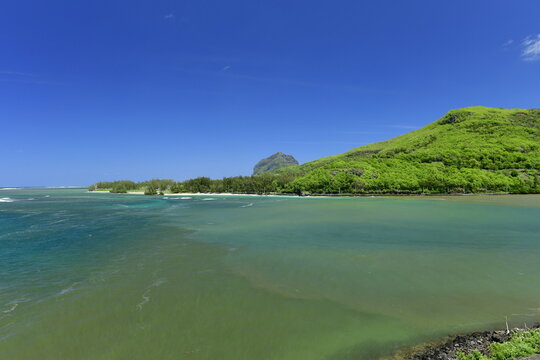 Maconde, Mauritius, Indian Ocean. A river mouth of fresh water mixing with the ocean salty water.