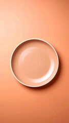 A top-down view of a round, peach-colored plate with a white rim on a matching background.