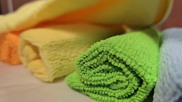 Macro close-up of soft microfiber fabric textures in various colors showing fiber details and stitching