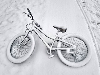 a bike covered in snow after a fresh snowfall