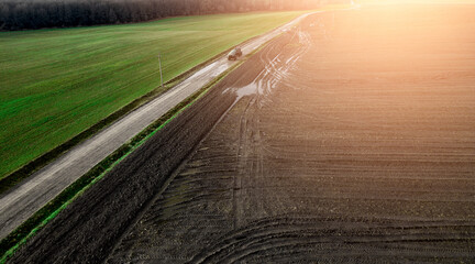 panorama of a farmer's field top view. The tractor makes organic fertilizers.