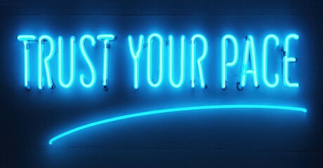 Bright blue neon sign displays positive message. Simple design, dark background creates strong contrast. Inspiring words offer encouragement.