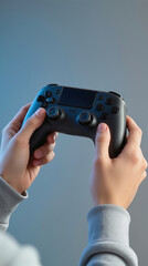 A person is gripping a black game controller with both hands. They are seated indoors with a simple background. Soft light creates a focus on the controller. 