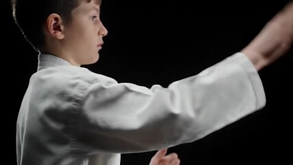 Young martial artist demonstrating karate techniques in a focused and dynamic performance.