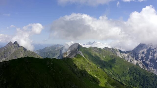 Aerial View of Green Mountin Slopes Leading to SharpRocky Summits