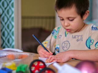 Boy Focusing on Writing and Drawing for Creative Skill Development