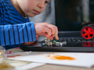 Boy Examining Mechanical Hardware Parts on Laptop for STEM Learning - Technical and Aesthetic Analysis: Future Engineer