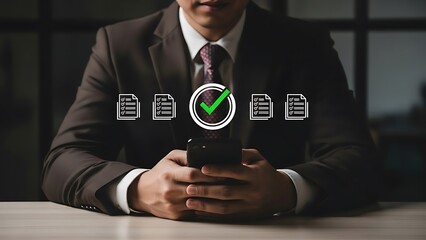 Businessman in a suit sitting at a desk using a smartphone with document icons and a green checkmark on the screen
