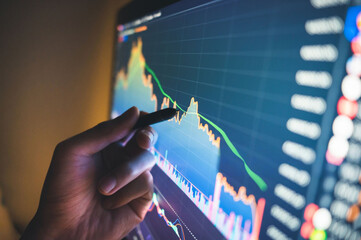 Analyzing financial data on a computer screen with a stylus