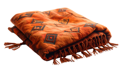Folded orange blanket with geometric designs and fringe, isolated on black