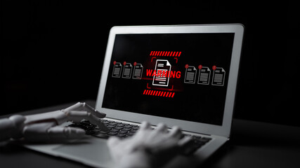 A robotic hand reaches toward a laptop displaying a warning sign, underscoring the importance of cybersecurity amid growing digital threats and technological advancements. Gantry