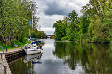 2025-05-06 A LOVELY CANAL WITH A BOAT AND NICE REFLECTION AND GREENERY ON THE BANKS IN NORWICH ENGLAND